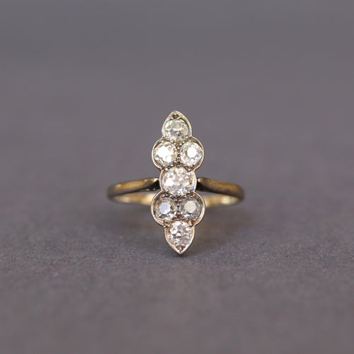 Antique north south ring with old cut diamonds. Early 20th century. Scalloped design. 1 carat diamond weight. Gilded vermeil band. Chernier shoulders.