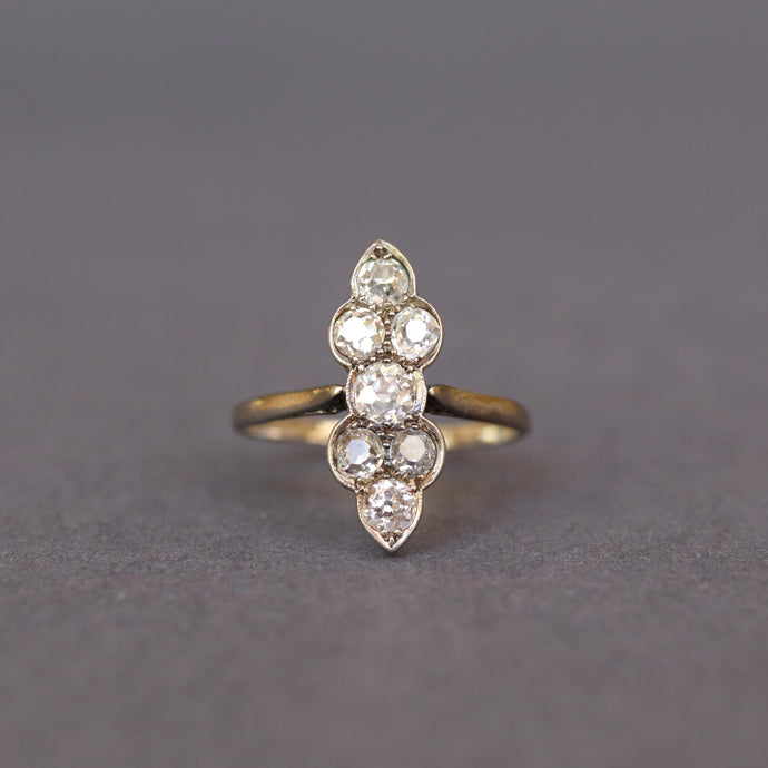 Antique north south ring with old cut diamonds. Early 20th century. Scalloped design. 1 carat diamond weight. Gilded vermeil band. Chernier shoulders.