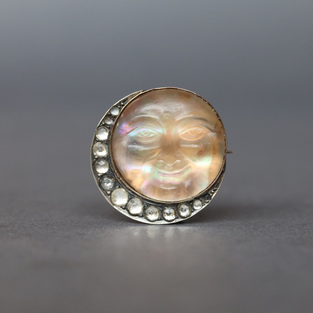 Man in the moon brooch. Antique man in the moon brooch. Victorian man in the moon brooch. Moon man brooch. Antique man in the moon pin. Man in the moon pin. Saphiret glass. Saphiret glass brooch. Opalescent glass. Opalescent glass brooch. Crescent moon brooch. Paste brooch. 