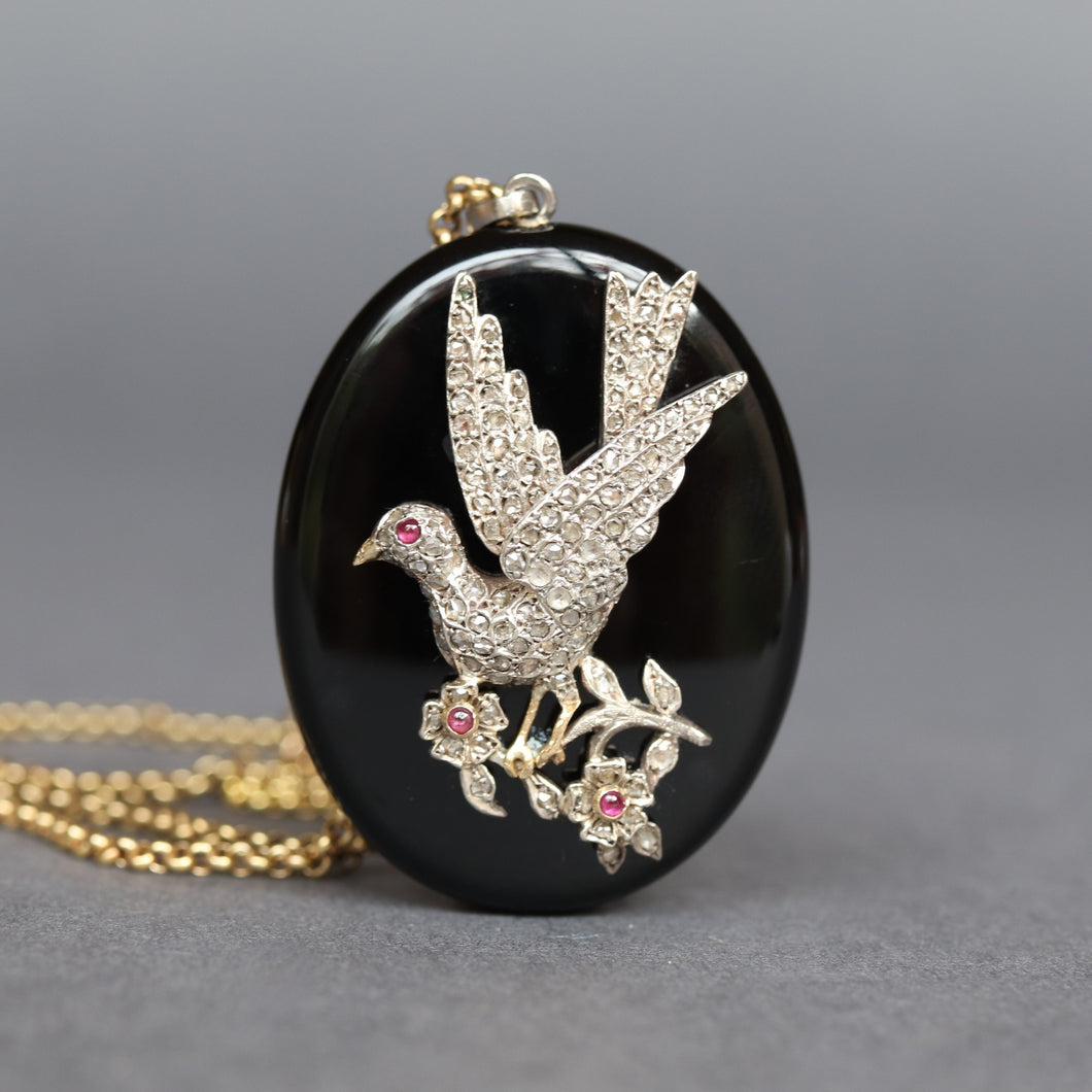 Dove locket. Diamond bird locket. Diamond dove locket. Dove mourning locket. Mourning locket. Black enamel locket. Victorian mourning locket. Antique mourning locket. Antique locket. Figural locket. Monogram locket. ME initials. EM initials. Oval locket. Antique diamond locket. Diamond pendant. Antique diamond pendant.