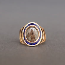 Load image into Gallery viewer, Antique Georgian sentimental ring with hairwork in a star pattern under crystal glass with a blue and white enamel border in 18ct rose gold. Oval shaped ring face. Band with arcs. CP initials. CP monogram. Mourning ring. Romantic antique ring.
