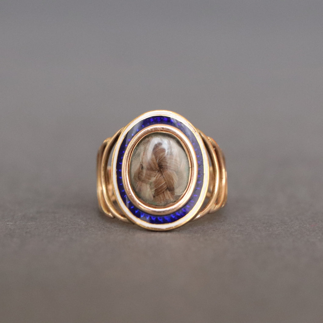 Antique Georgian sentimental ring with hairwork in a star pattern under crystal glass with a blue and white enamel border in 18ct rose gold. Oval shaped ring face. Band with arcs. CP initials. CP monogram. Mourning ring. Romantic antique ring.