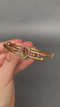 Load and play video in Gallery viewer, Antique Victorian era bypass bangle with garnets in 10ct gold casing
