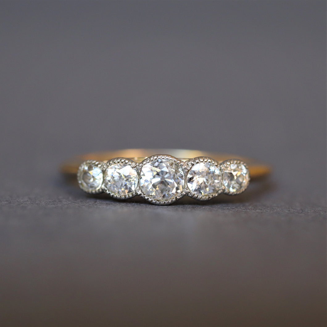 Antique five stone diamond ring. Antique diamond ring. Edwardian diamond ring. Antique diamond engagement ring. Edwardian engagement ring. Millegrain setting. Platinum setting. Old European cut diamond ring. Antique old cut diamond ring. Old cut diamond ring.