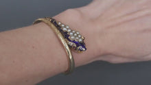 Load and play video in Gallery viewer, Antique Victorian era pearl, garnet &amp; enamel snake bangle in 14ct gold
