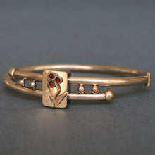 Load image into Gallery viewer, Antique Victorian era bypass bangle with garnets in 10ct gold casing
